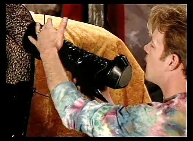 Busty blonde mistress enjoys having her boots licked by young foot worshiper