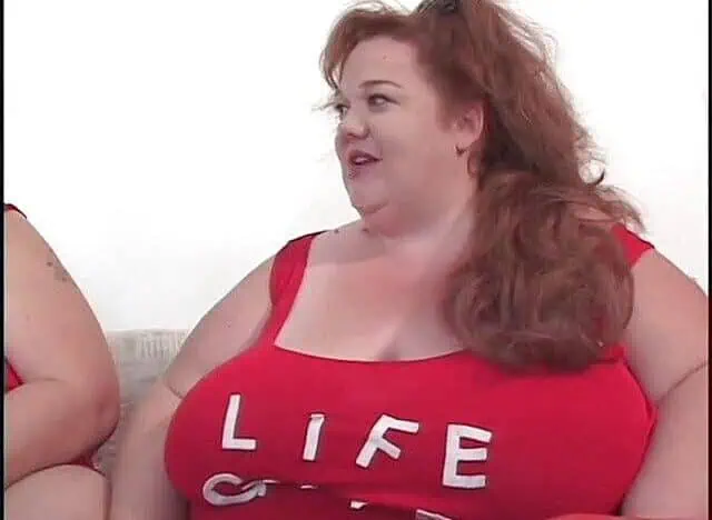Fat bellied chick in red uniform rides one long stick