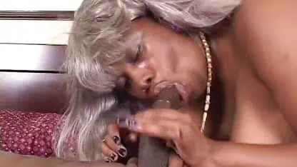Cute black man gets his hard cock blown by a granny on the bed