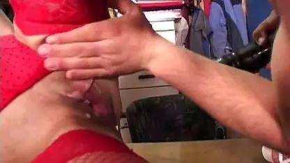 Horny cougar in red enjoys toy action in a three-way with two guys